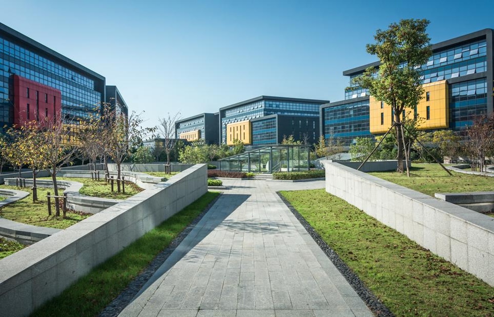 Stunning Modern Office Complex with Lush Landscaping Under Bright Blue Sky
